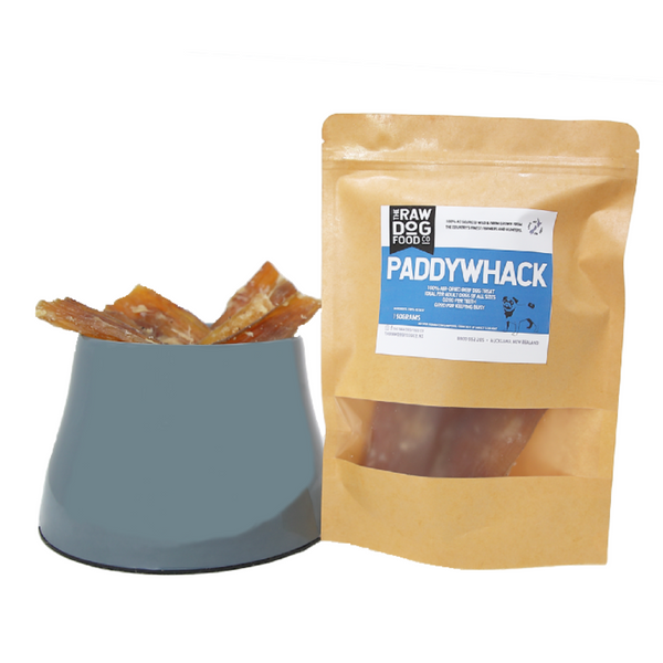 Packaged air-dried beef paddywhack dog treats next to a bowl with some treats visible.