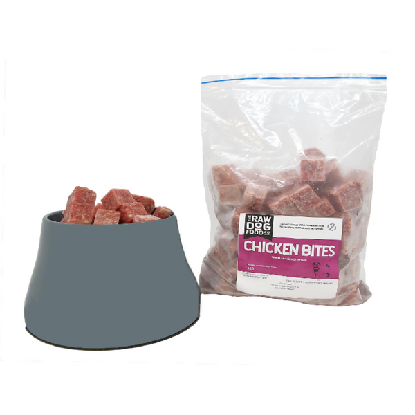 A package of frozen chicken bites for dogs next to a bowl filled with the same chicken bites.