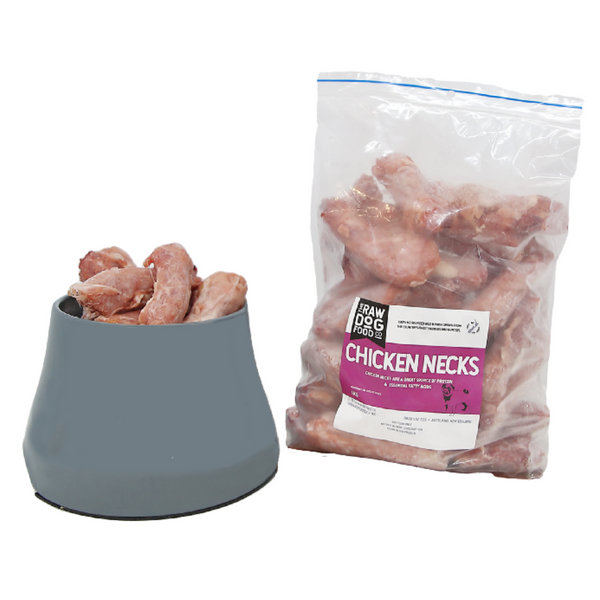 A package of frozen chicken necks for dogs beside a bowl filled with the same chicken necks.