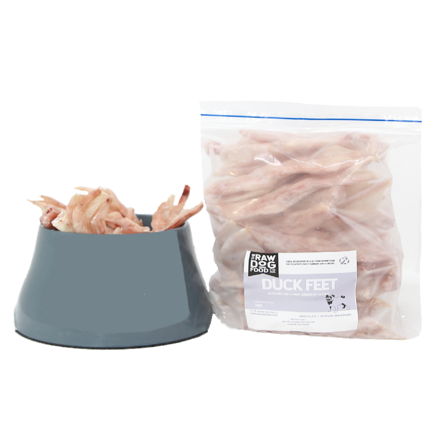 A package of frozen duck feet pet food next to a bowl filled with duck feet.
