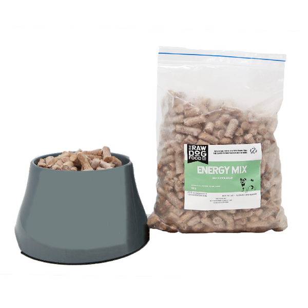 A package of 'Full of Energy Mix' raw pet food pellets next to a bowl filled with the same pellets, indicating the product is meant for feeding pets.