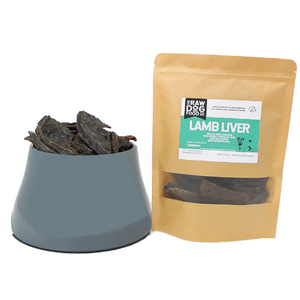 A package of air-dried lamb liver slices next to a bowl filled with the same slices.