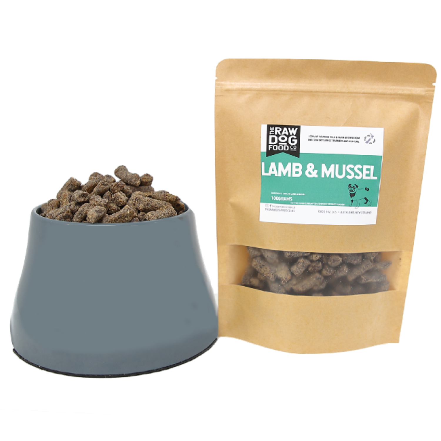 A package of Air-Dried Lamb & Mussel Bites dog treat next to a bowl filled with the same treats. The package is labeled with the product name and the brand Raw Dog Food Co.