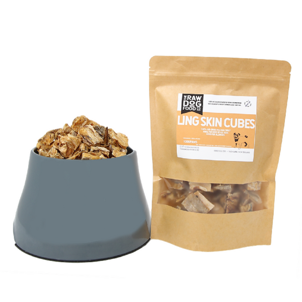 A package of air-dried ling skin cubes next to a bowl filled with the same treats for dogs.