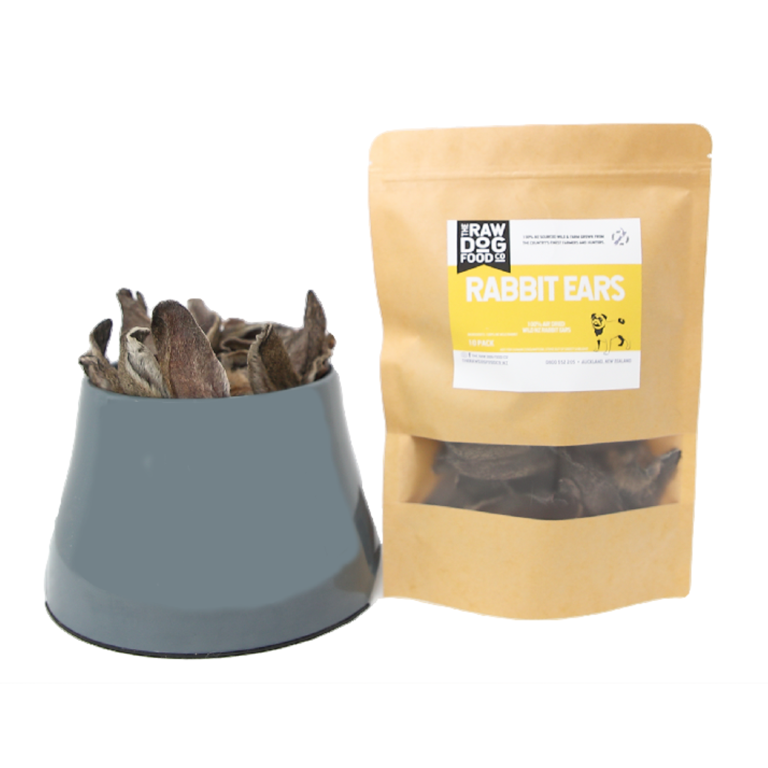 A package of air-dried rabbit ears pet treats next to a bowl filled with the same treats.