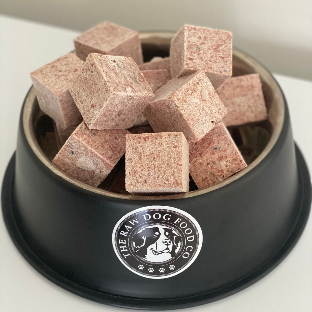 A bowl of frozen chicken and salmon mince pet food.