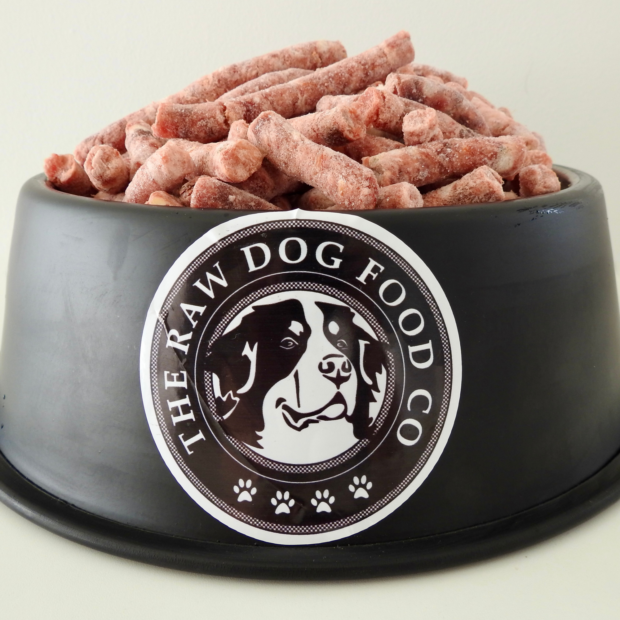 A dog bowl full of frozen energy raw pellets
