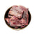 An image of a bowl of frozen goat chunks for pet food.