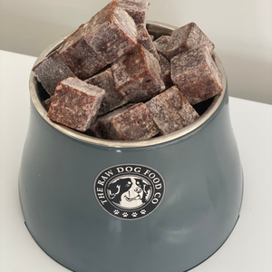 A bowl of frozen hare mince bites for pet food.