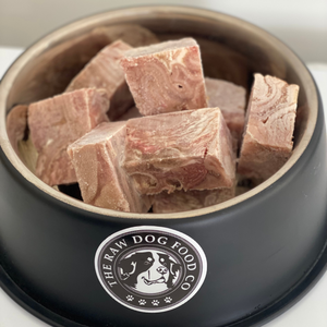 An image of a dogs bowl full of frozen lamb tripe cubes