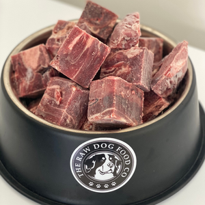 A picture of a bowl of frozen venison meat for pets. 