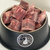 A picture of a bowl of frozen venison meat for pets. 